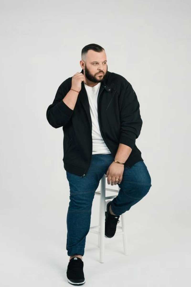 Black Bomber Jacket and Blue Jeans