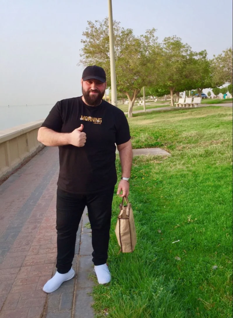 Black Graphic T-Shirt, Black Pants, and Black Baseball Cap