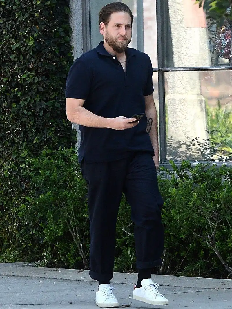 Black Polo Shirt With Cuffed Black Pants and White Sneakers