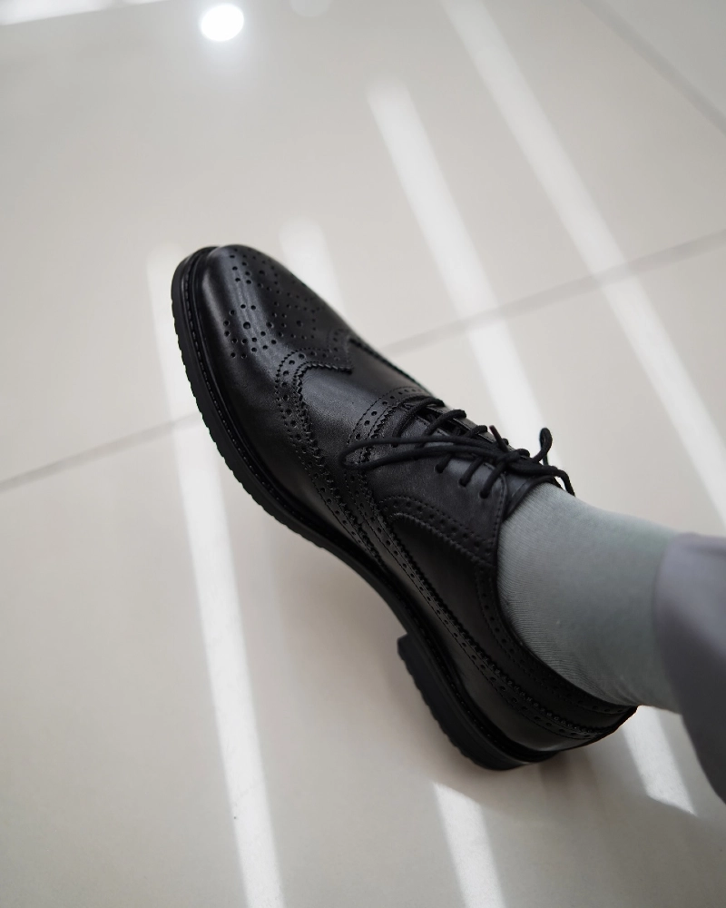Black Wingtip Derby Shoes with Light Grey Trousers