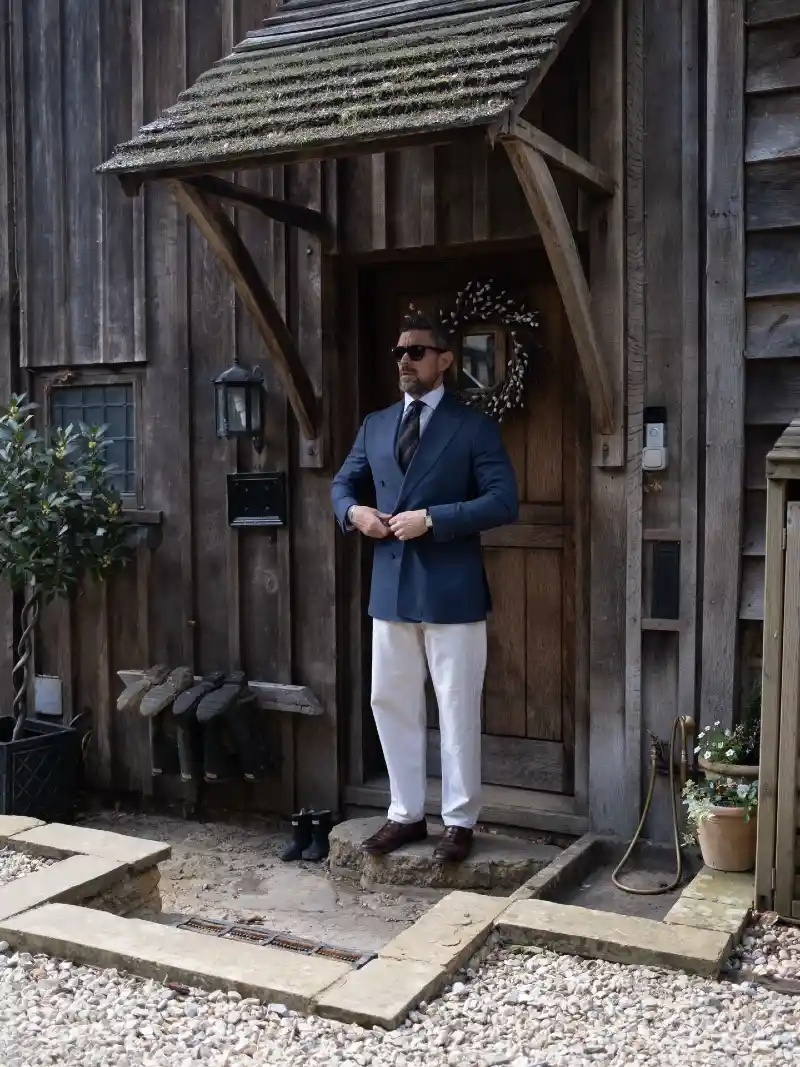 Blue Double-Breasted Blazer, White Trousers, and Striped Tie