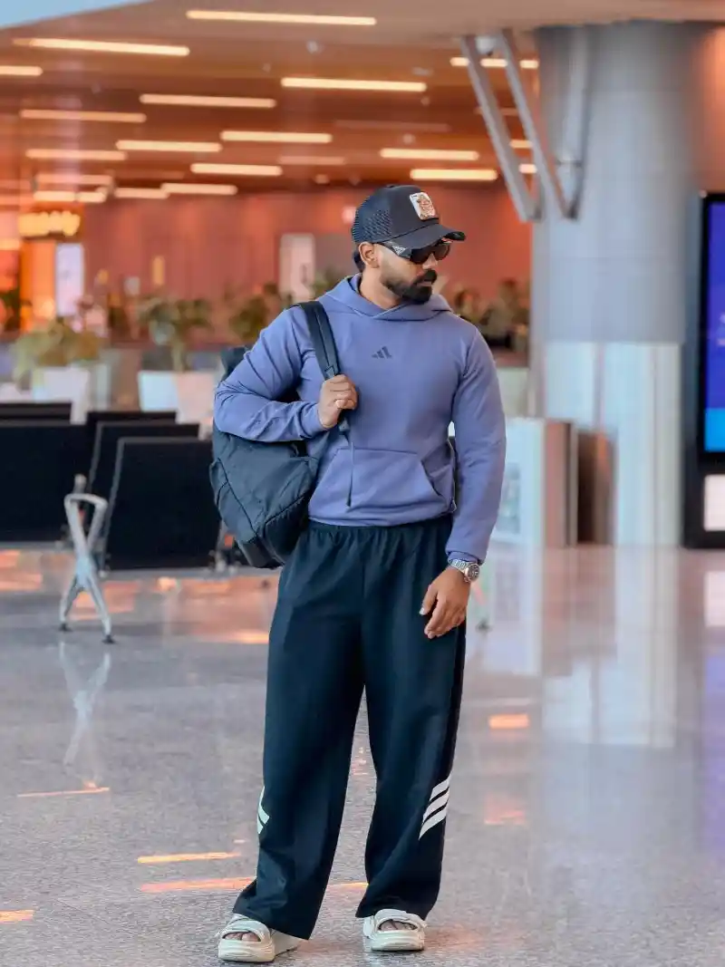 Blue Hoodie, Black Track Pants, and Sandals