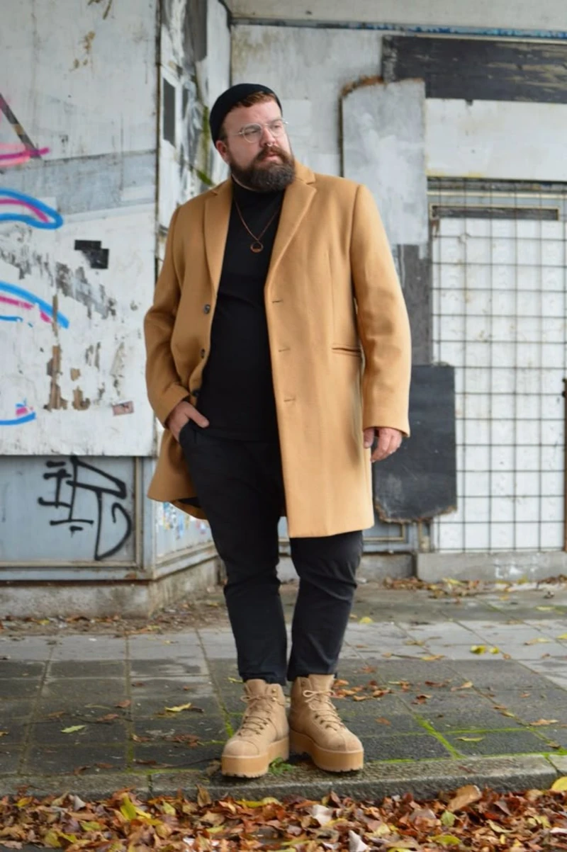 Camel Coat With Black Layers and Tan Boots