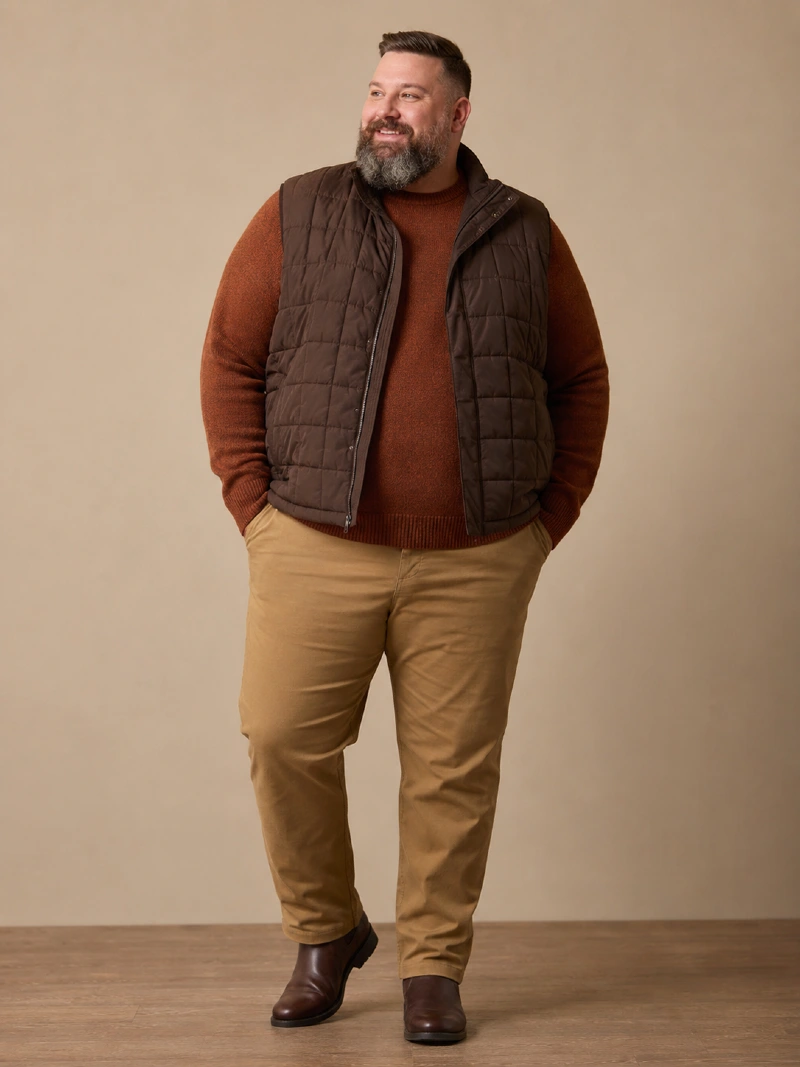 Dark Brown Quilted Vest, Rust Crewneck Sweater, and Tan Chinos