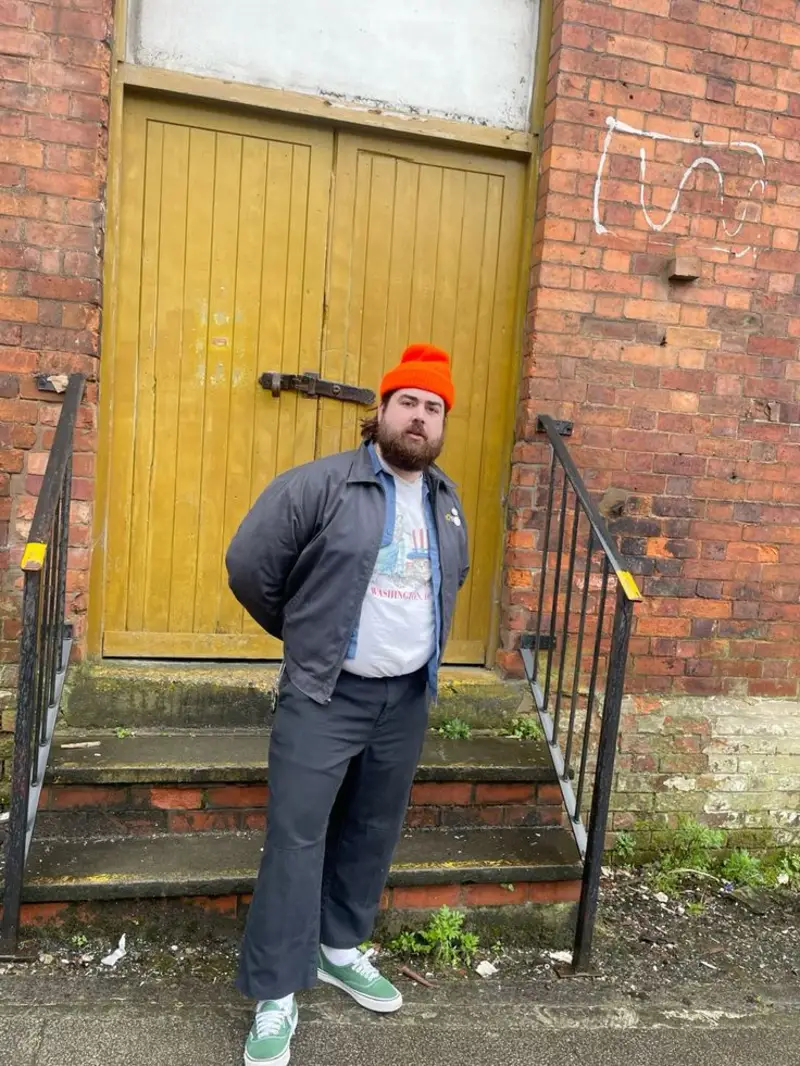 Dark Grey Work Jacket, Graphic Tee, and Bright Beanie