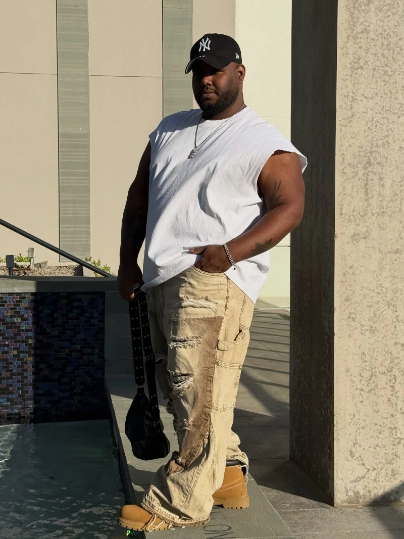Distressed Tan Cargo Pants with a White Sleeveless Tee