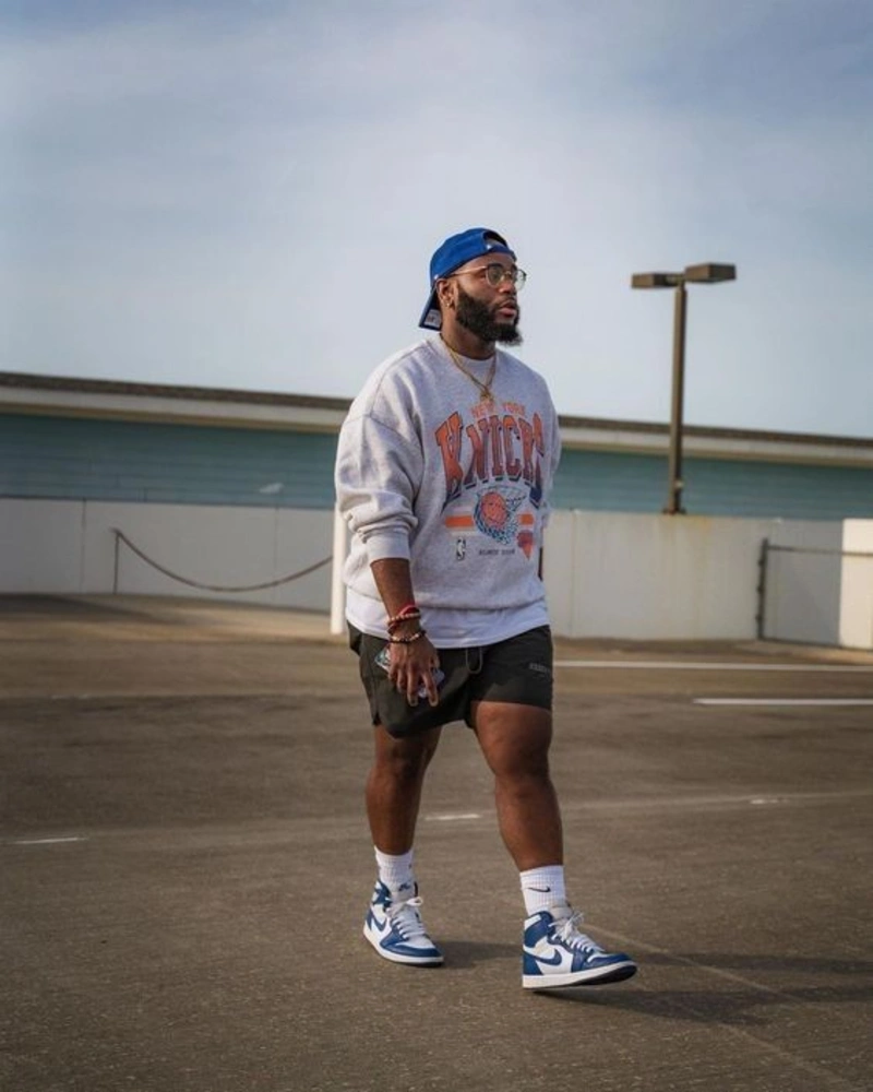 Gray Graphic Sweatshirt with Black Shorts and Blue High-Top Sneakers