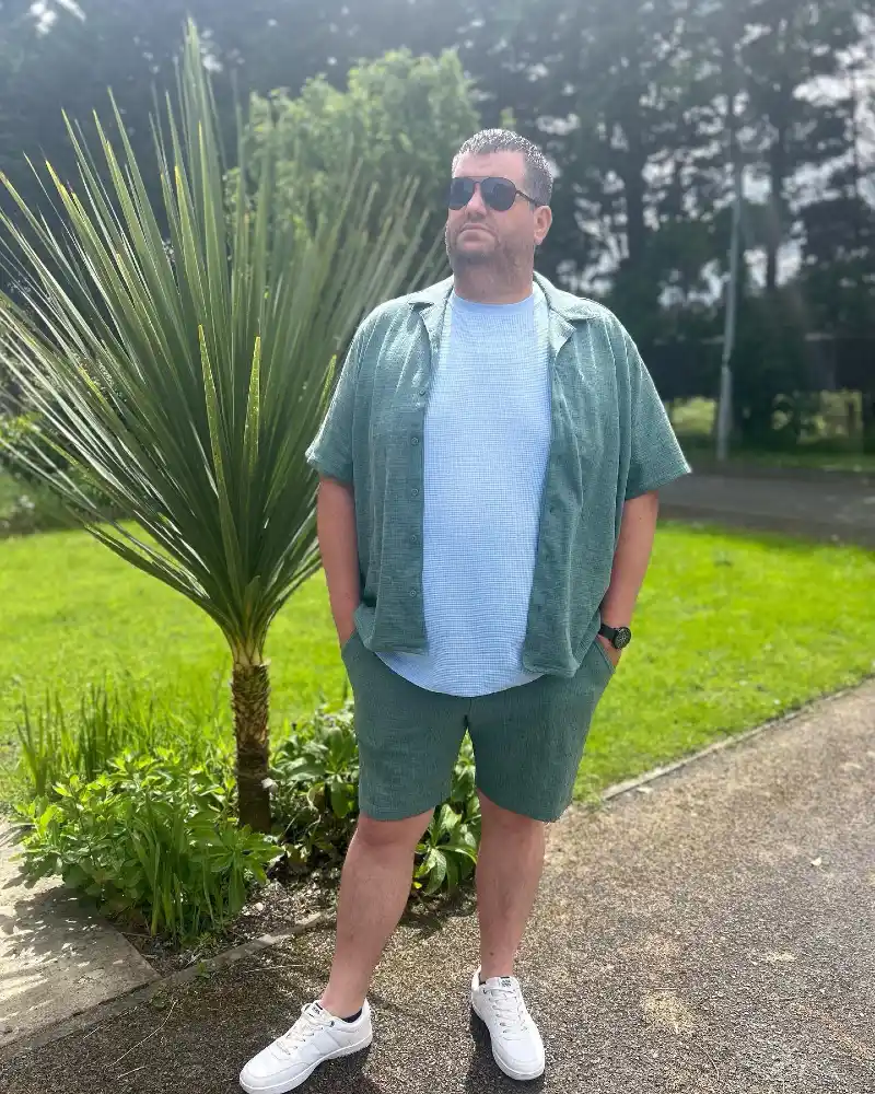 Green Short-Sleeve Button-Up Shirt, Light Blue T-Shirt, and Green Shorts