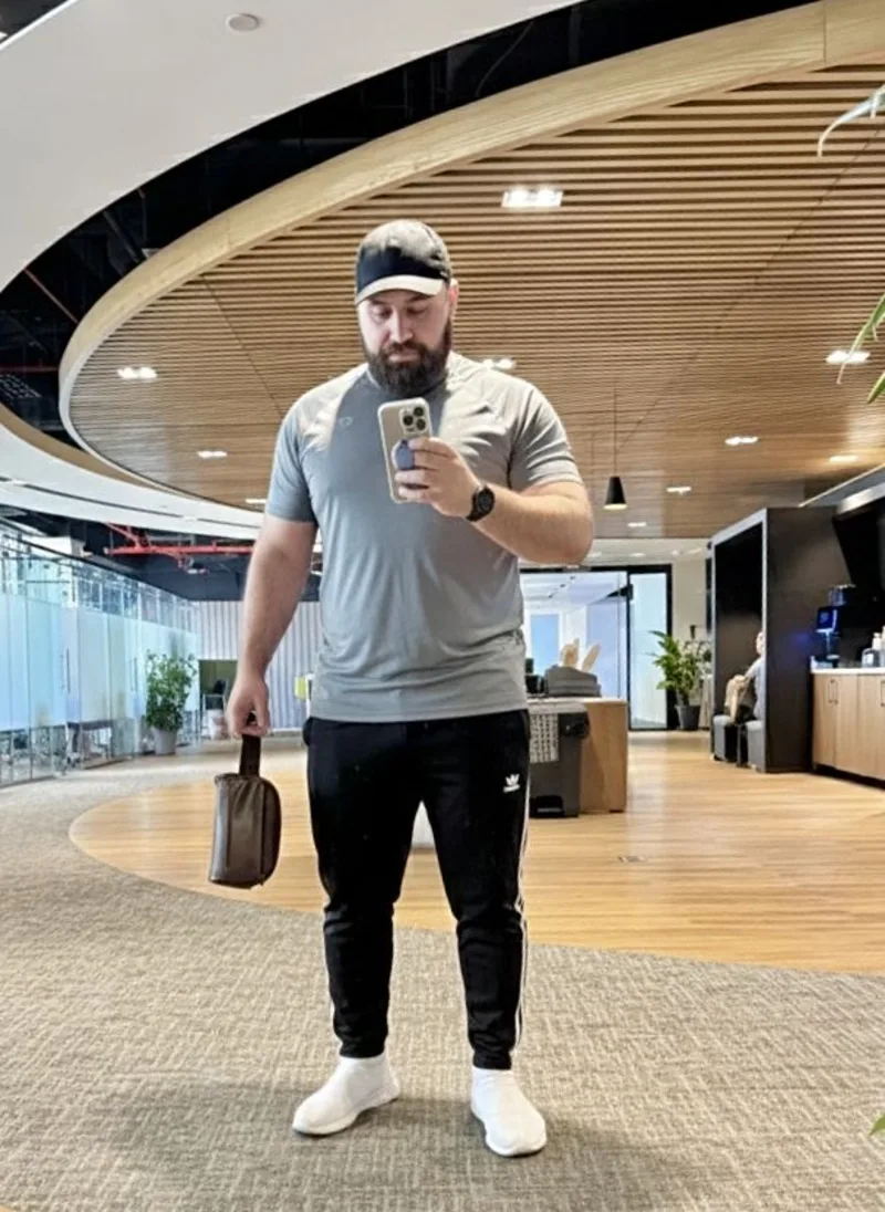 Grey Athletic T-Shirt, Black Track Pants, and White Sneakers