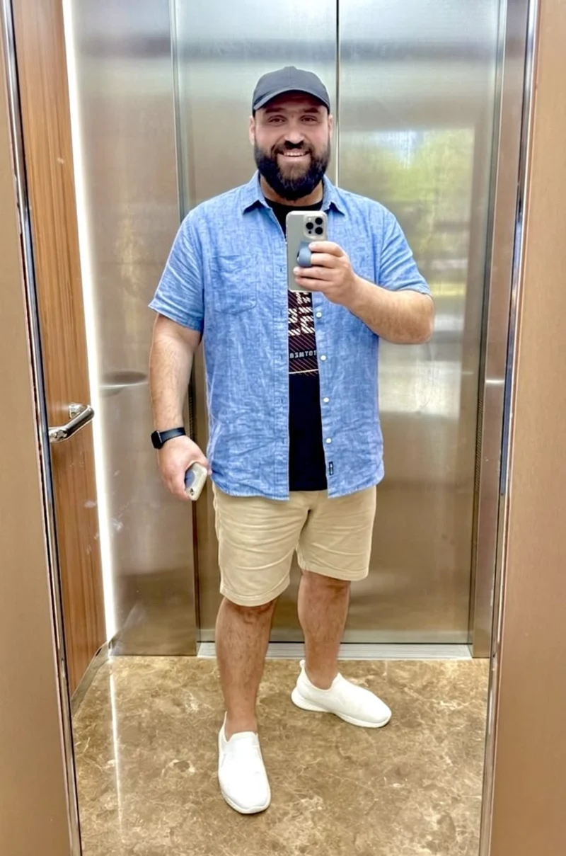 Light Blue Short-Sleeve Button-Up, Graphic Tee, Beige Shorts, and White Slip-On Sneakers