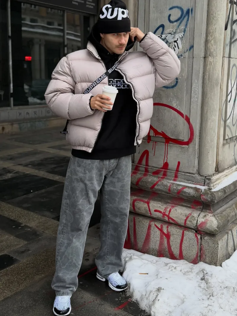 Light Grey Puffer Jacket with Black Hoodie and Patterned Jeans