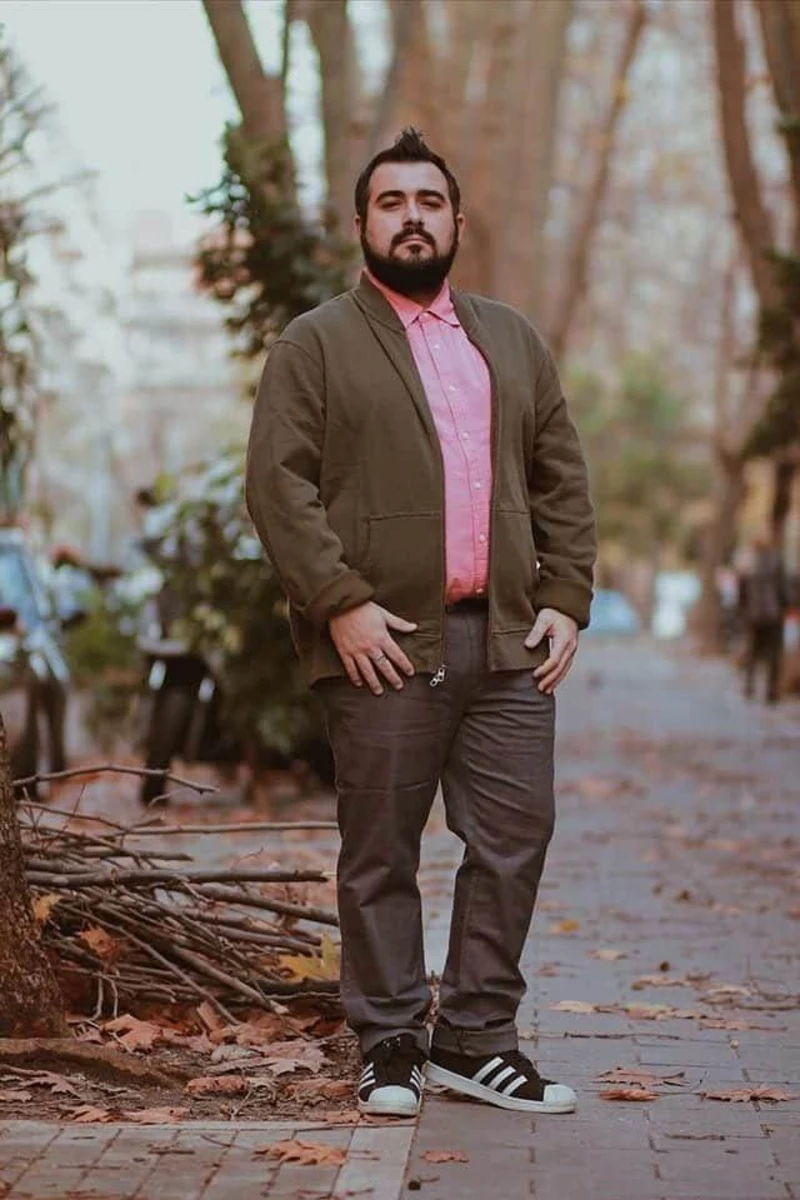 Olive Bomber Jacket, Pink Button-Down Shirt, and Grey Pants