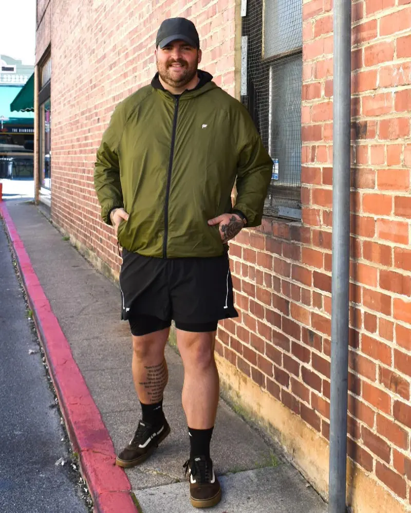 Olive Packable Jacket and Black Shorts