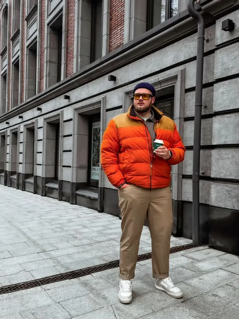 Orange Puffer Jacket with Khaki Chinos and Beanie