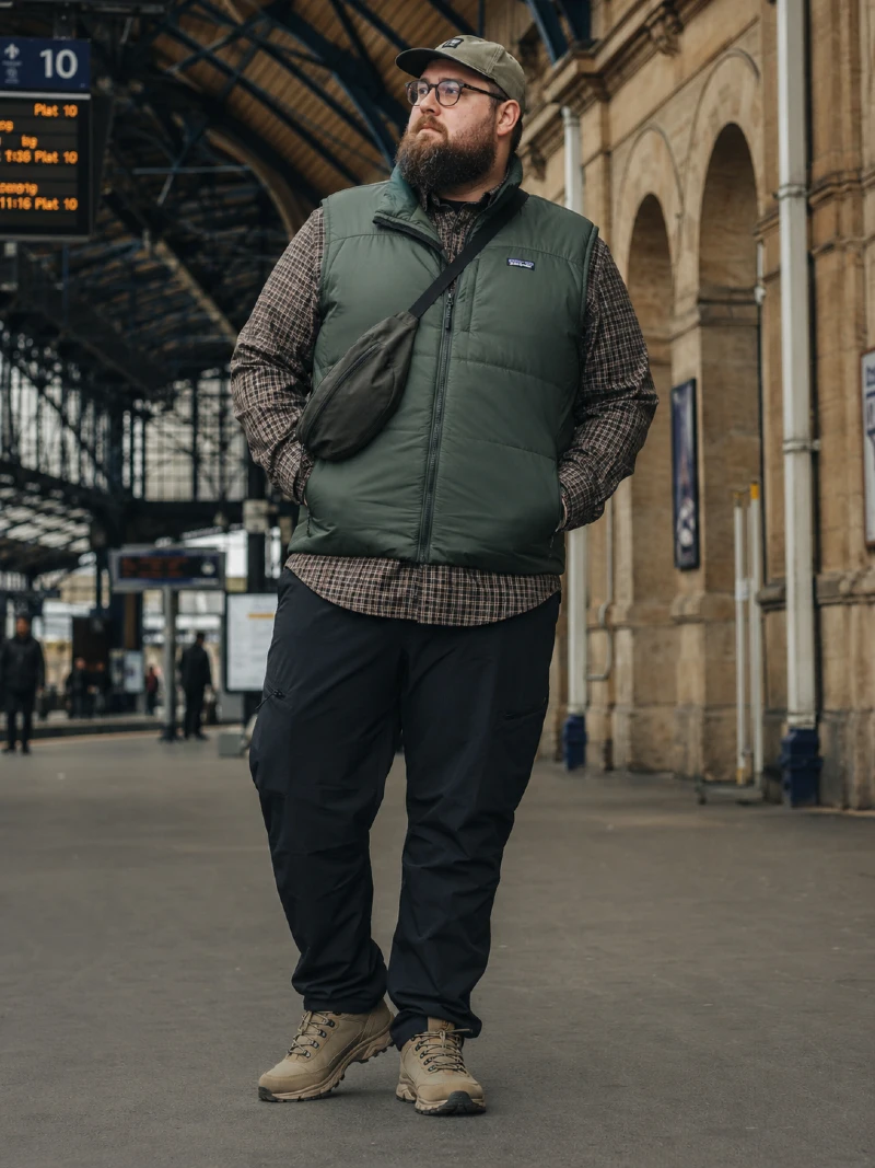 Puffer Vest, Plaid Button-Down Shirt, Black Pants, Crossbody Bag, Baseball Cap, and Hiking Shoes