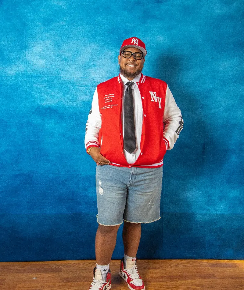 Red Varsity Jacket With Denim Shorts and High-Top Sneakers