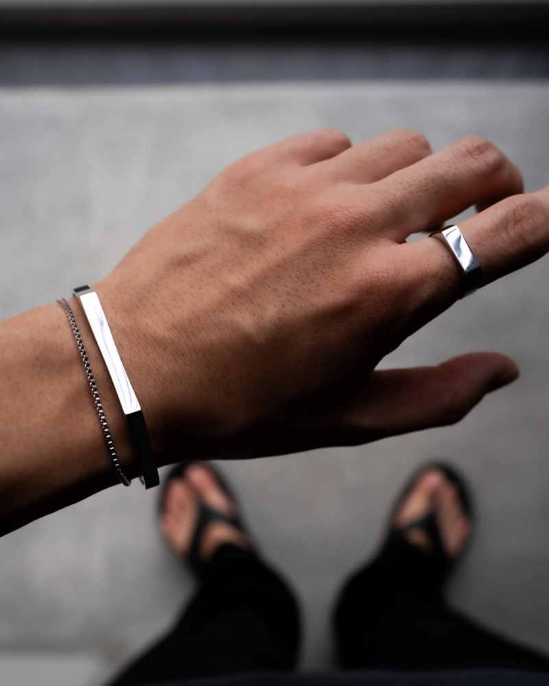 Silver Cuff, Thin Chain Bracelet, Ring, Dark Pants, and Sandals