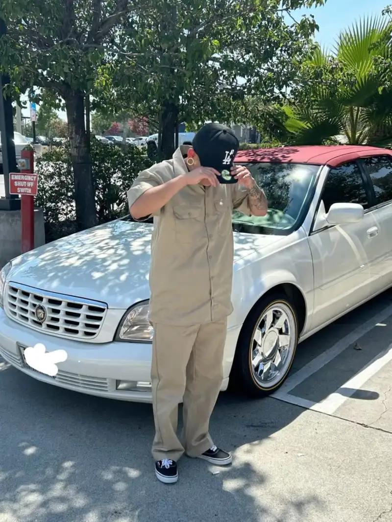 Tan Button-Down Work Shirt, Tan Pants, and Black LA Baseball Cap