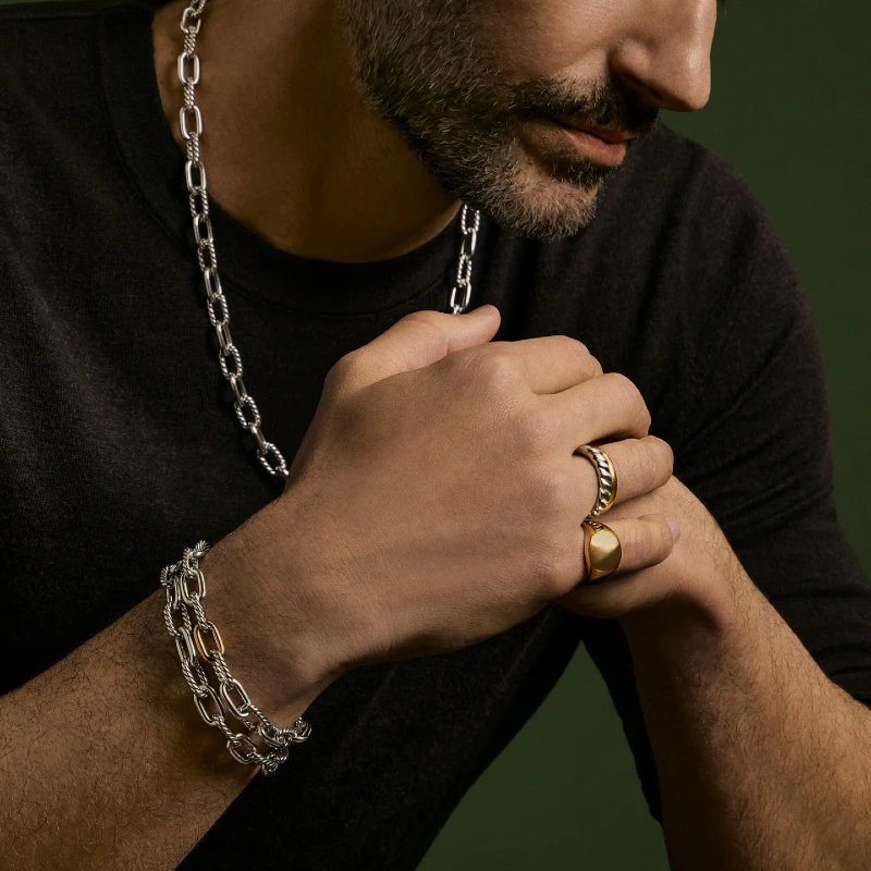 Two-Tone Oval Link Chain, Stacked Bracelets, Rings, and Dark Long-Sleeve Shirt