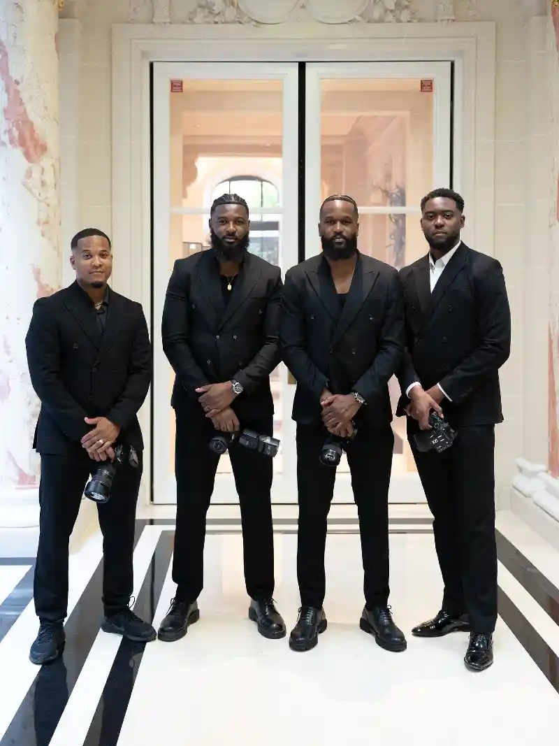 black double-breasted blazers, black dress trousers, and black dress shoes