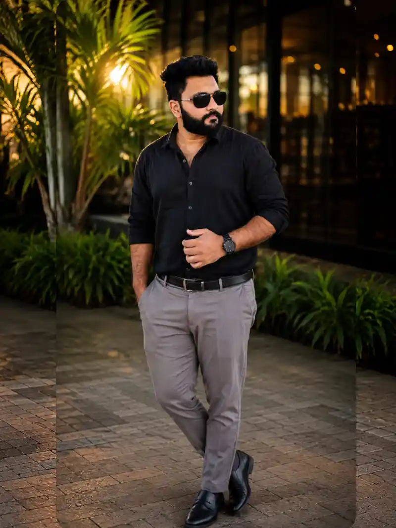 black long-sleeve button-up shirt, grey dress trousers, black leather loafers, and accessories